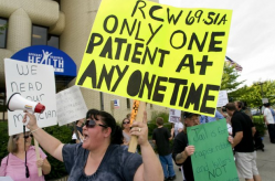 Dispensary owner Chantel Jackson joins dozens of people Monday, Sept. 14, 2009, to protest the Spokane Police Department’s recommendation to close of all the city’s medical marijuana dispensaries last week.